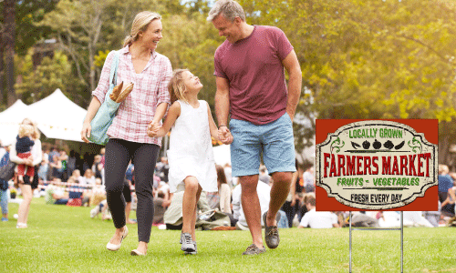 Agricultural yard sign with a family in the background.